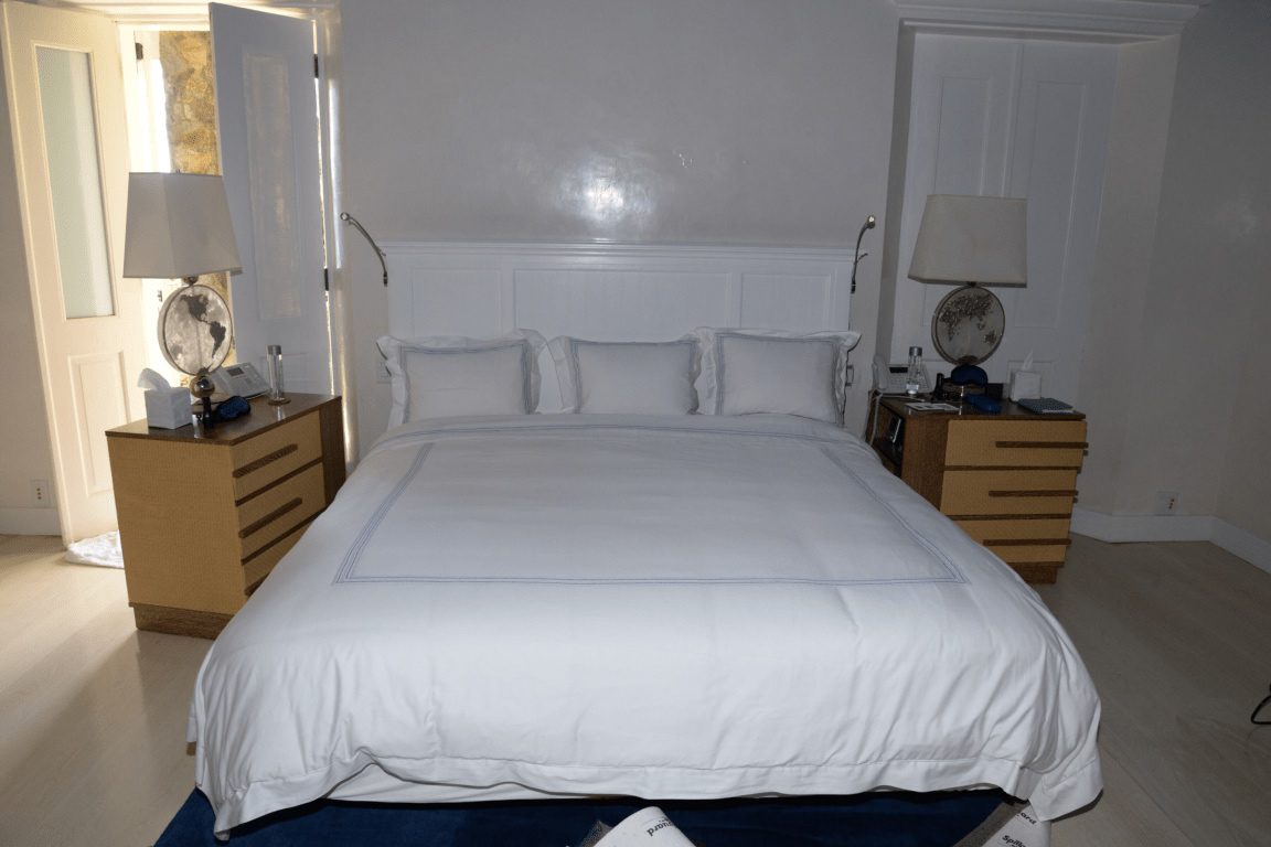 Simple calm bedroom with minimal bedding in soft light
