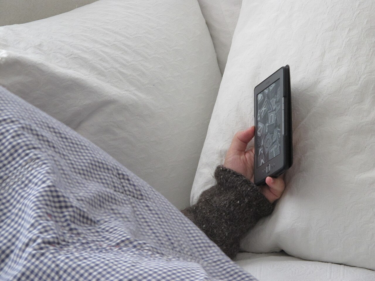 Winding down in bed with an e-reader before sleep