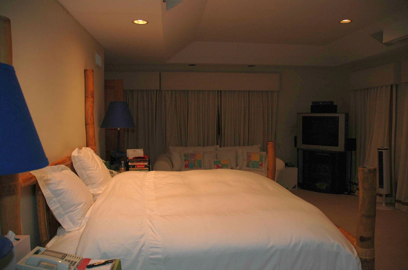 Cozy bedroom with a neatly made bed in soft evening light