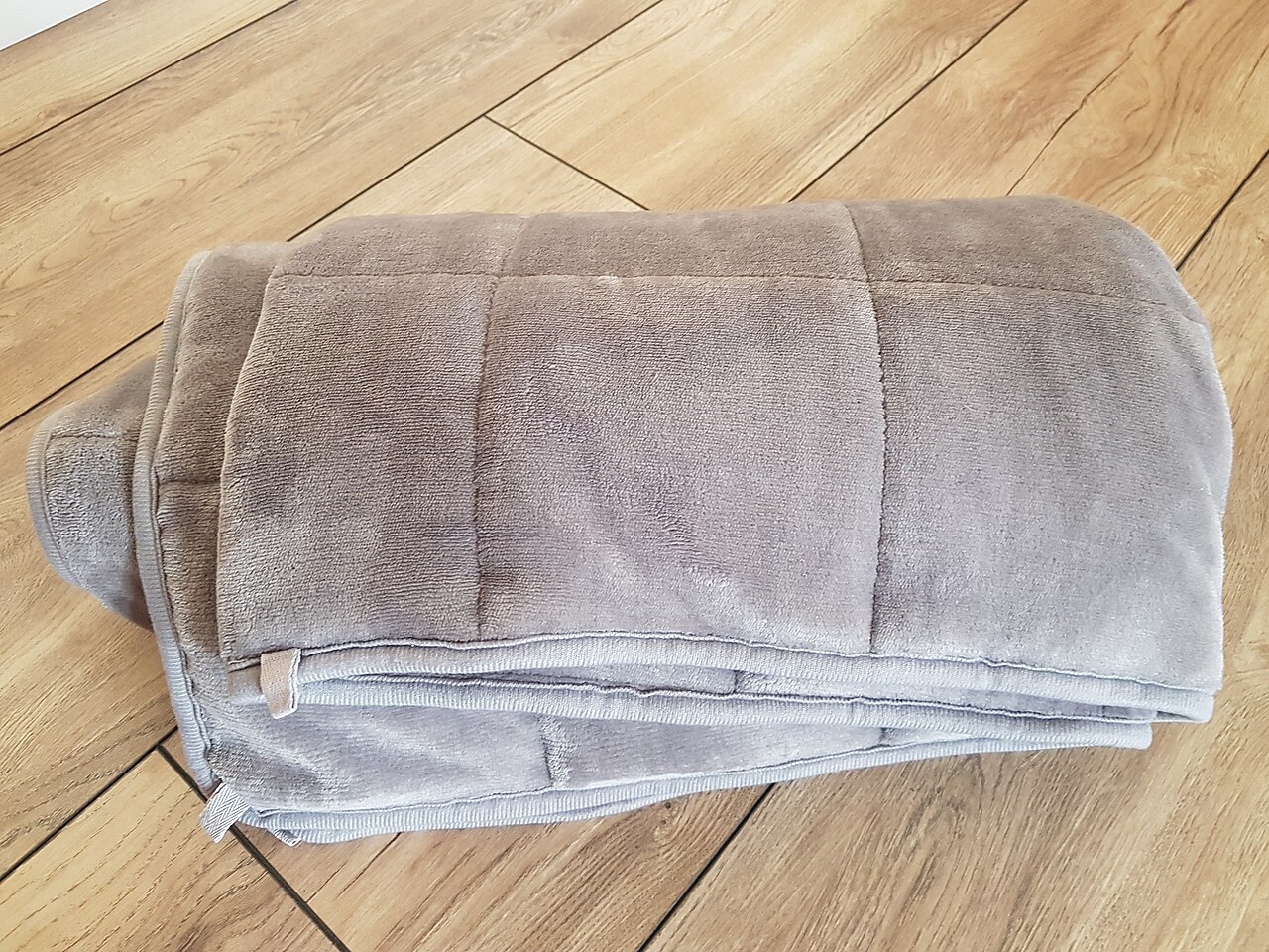 Textured weighted blanket folded neatly on a bed